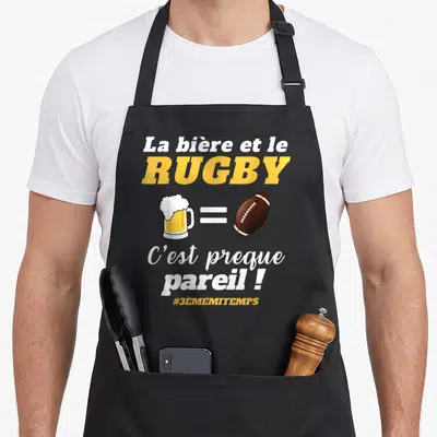 Tablier de cuisine noir avec une bière, un ballon de rugby et le texte La bière et le rugby C'est preque pareil