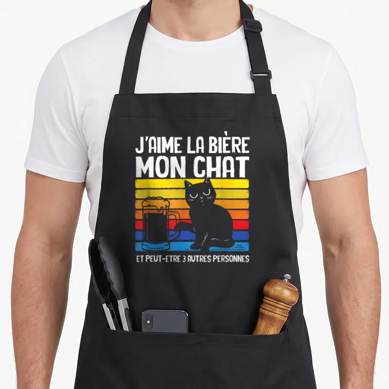 Tablier de cuisine noir avec un chat gris posant sa patte sur une bière et du texte humoristique en blanc.