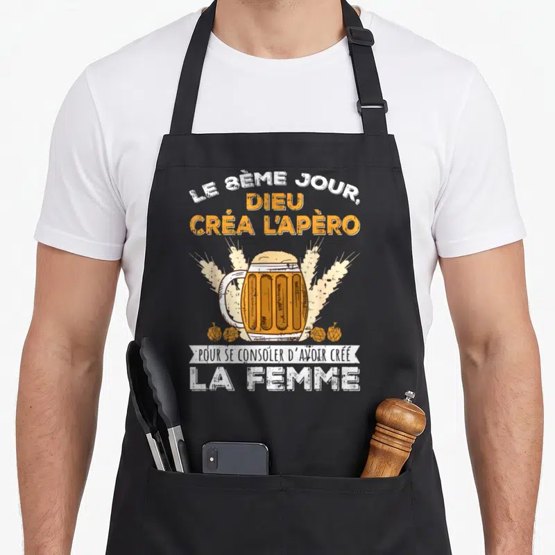 Tablier de cuisine noir avec une grande coupe de bière et le texte humoristique sur fond uni.
