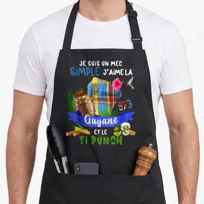 Tablier de cuisine noir avec illustration Guyane 973 Ti Punch et colibri sur fond uni.