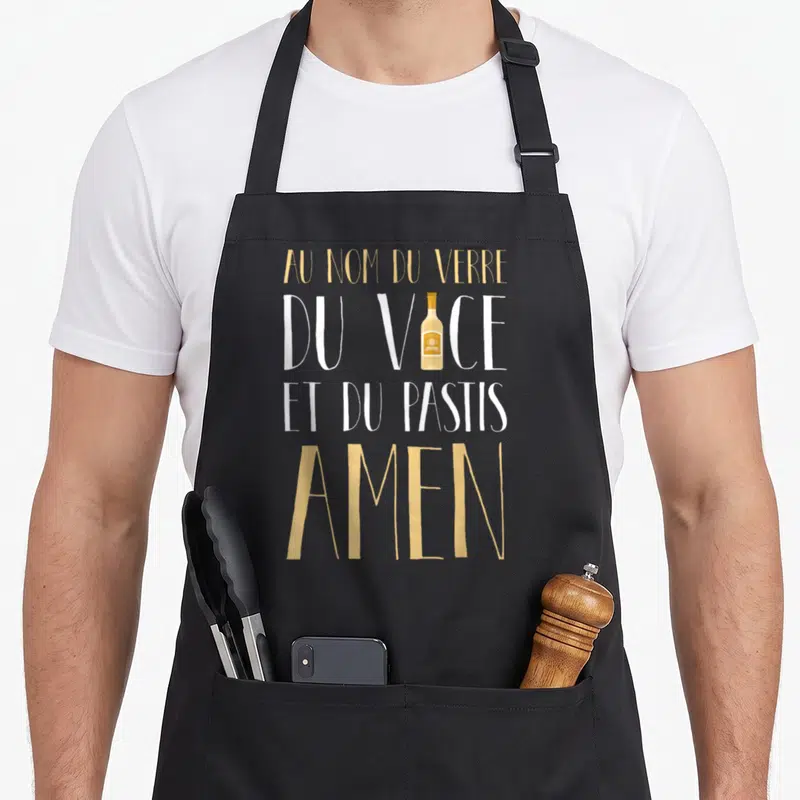 Tablier de cuisine noir avec Au nom du verre du vice et du Pastis Amen et une petite bouteille de pastis au centre.