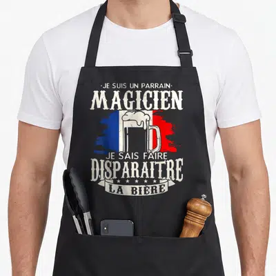 Tablier de cuisine noir avec illustration verre de bière et texte Je suis un parrain magicien sur fond tricolore français.