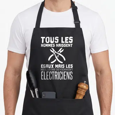 Tablier de cuisine noir avec inscription Tous les hommes naissent égaux mais les meilleurs deviennent électriciens et deux pinces croisées.