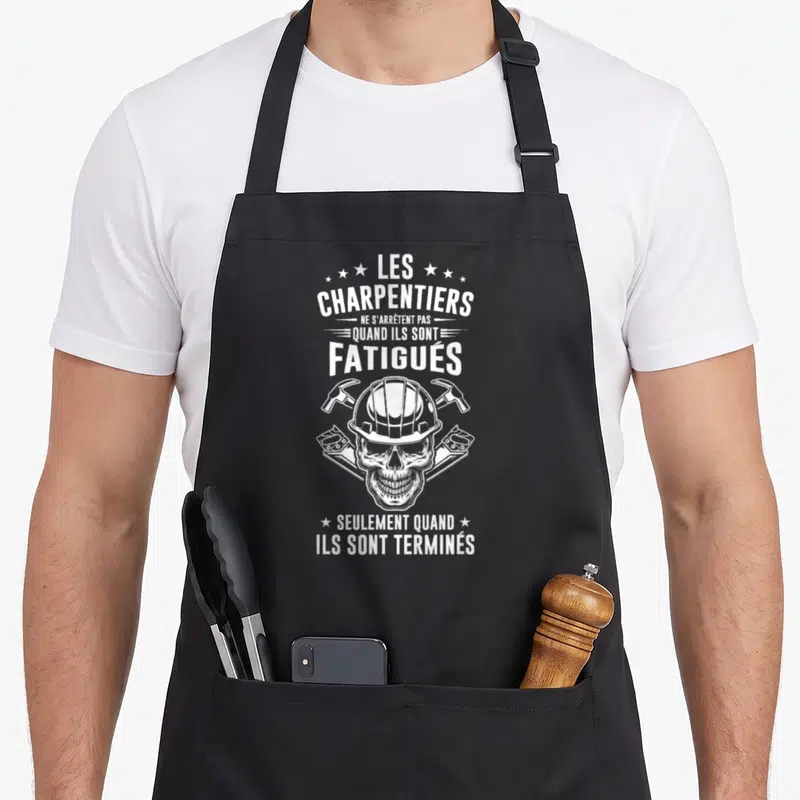Tablier de cuisine noir avec un crâne portant un casque de chantier et des outils croisés en blanc.