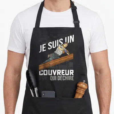 Tablier de cuisine noir avec illustration d'un couvreur barbu sur une poutre en bois et texte blanc Je suis un couvreur qui déchire.