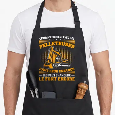 Tablier de cuisine noir avec illustration orange et texte sur les pelleteuses et l'enfance