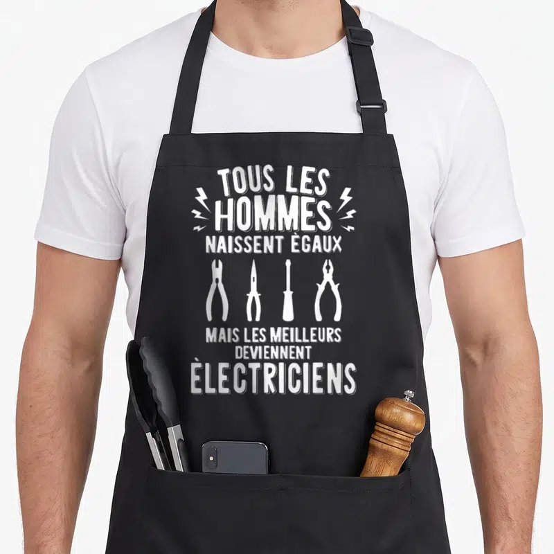 Tablier de cuisine noir avec inscription Tous les hommes naissent égaux mais les meilleurs deviennent électriciens et quatre outils blancs.