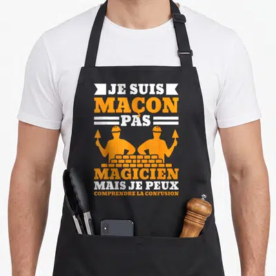 Tablier de cuisine noir avec silhouettes orange de maçons et texte Je suis maçon pas magicien mais je peux comprendre la confusion.