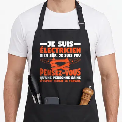 Tablier de cuisine noir avec inscription Je suis électricien bien sûr je suis fou et deux pinces croisées en orange.