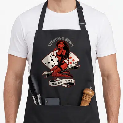 Tablier de cuisine noir avec une illustration d'une femme diablesse rouge tenant un marteau et des cartes à jouer.