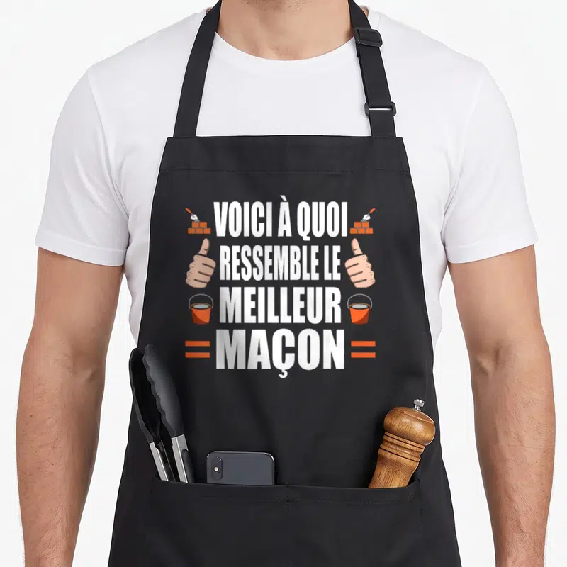 Tablier de cuisine noir avec inscription Voici à quoi ressemble le meilleur maçon et illustrations de mains et seaux orange.