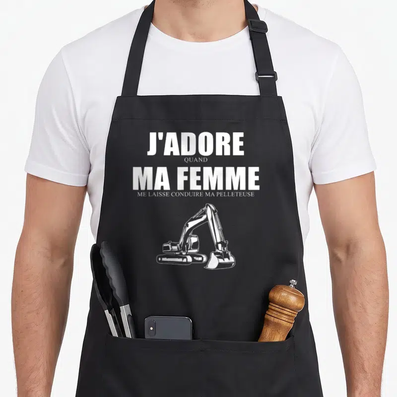 Tablier de cuisine noir avec l'inscription J'adore quand ma femme me laisse conduire ma pelleteuse et une excavatrice blanche.