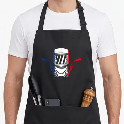 Tablier de cuisine noir avec illustration de casque de soudure aux couleurs du drapeau français et deux poignées de pistolet.