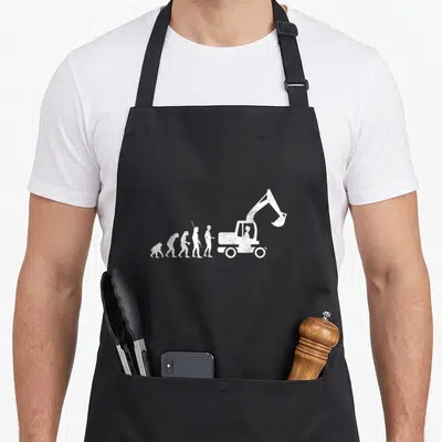 Tablier de cuisine noir avec illustration blanche de l'évolution humaine finissant par une pelle mécanique
