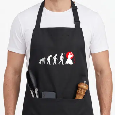 Tablier de cuisine noir avec une illustration blanche représentant l'évolution humaine finissant par un pratiquant d'Aikido face à un cercle rouge.
