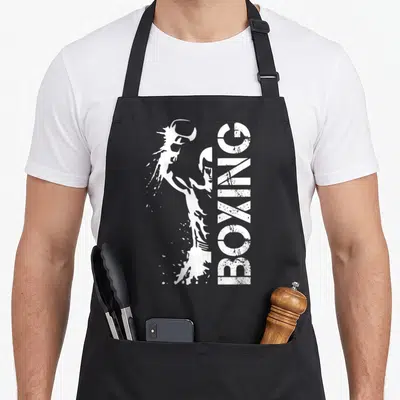 Tablier de cuisine noir avec illustration blanche d'un boxeur et l'inscription BOXING verticale.
