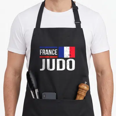 Tablier de cuisine noir avec inscription France Judo et drapeau tricolore français stylisé.