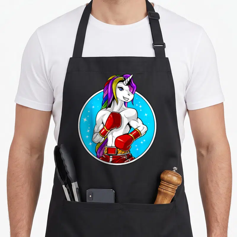 Tablier de cuisine noir avec une licorne boxeuse musclée aux gants rouges et à la crinière multicolore.