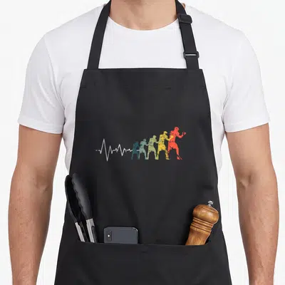 Tablier de cuisine noir avec silhouette de boxeur multicolore et ligne de battement de cœur blanche stylisée.