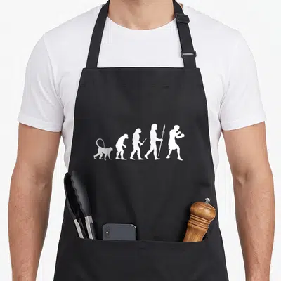 Tablier de cuisine noir avec illustration blanche représentant l'évolution de la boxe jusqu'au pugiliste aux gants.