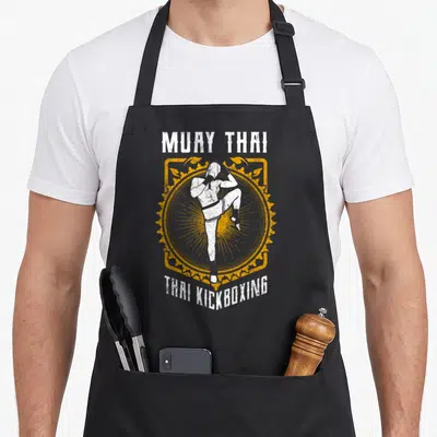 Tablier de cuisine noir avec illustration d'un lutteur de Muay Thai et texte Muay Thai Thai Kickboxing.