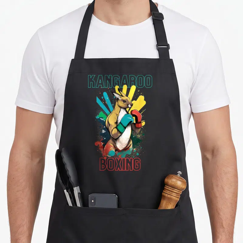 Tablier de cuisine noir avec illustration d'un kangourou en gants de boxe colorés et texte stylisé.