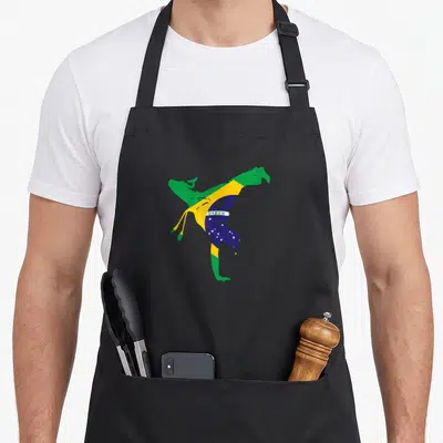 Tablier de cuisine noir avec silhouette capoeira aux couleurs du drapeau brésilien et l'inscription ORDEN, style graphique minimaliste.