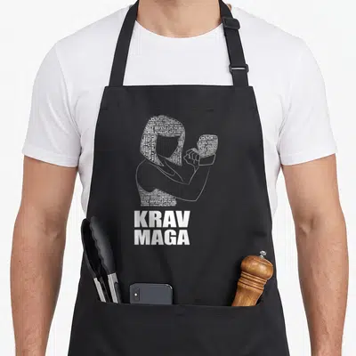 Tablier de cuisine noir avec silhouette typographique d'auto défense et texte Krav Maga en blanc.