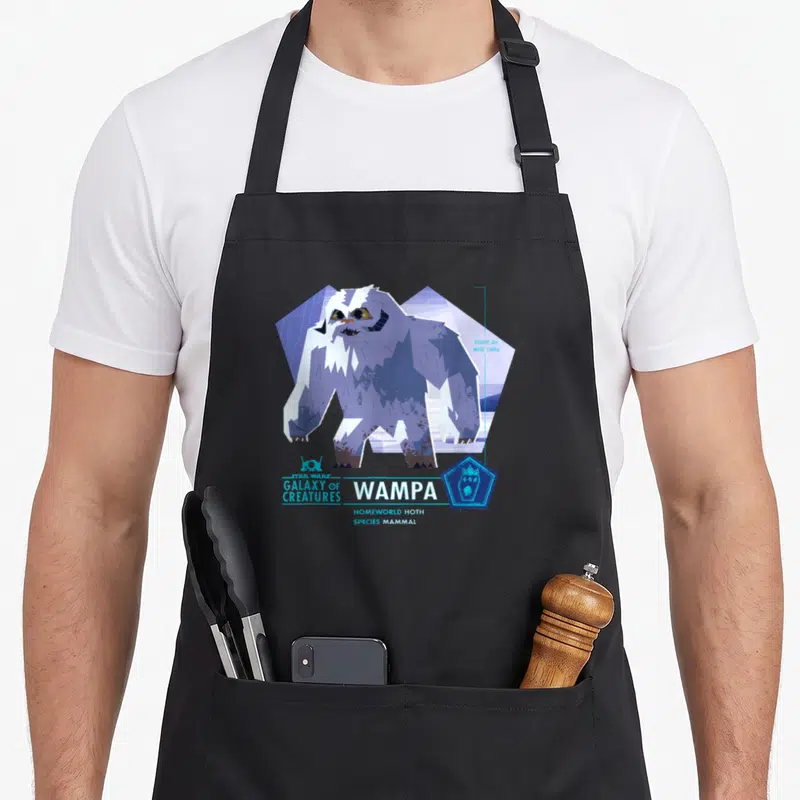 Tablier de cuisine noir avec illustration stylisée d'un Wampa et texte Galaxy of Creatures Wampa Mammal Hoth.