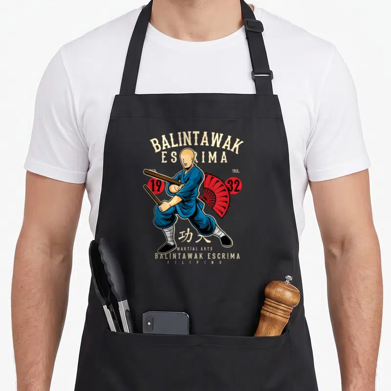 Tablier de cuisine noir avec illustration d'un combattant de Balintawak Escrima tenant des bâtons et un parasol rouge.