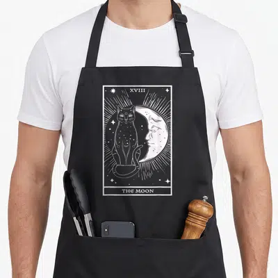 Tablier de cuisine noir avec illustration blanche carte tarot chat et croissant de lune visage étoilé rayons lumineux