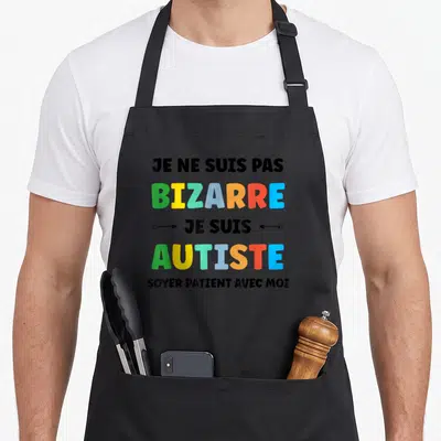 Tablier de cuisine noir avec texte multicolore Je ne suis pas bizarre je suis Autiste Soyer patient avec moi.