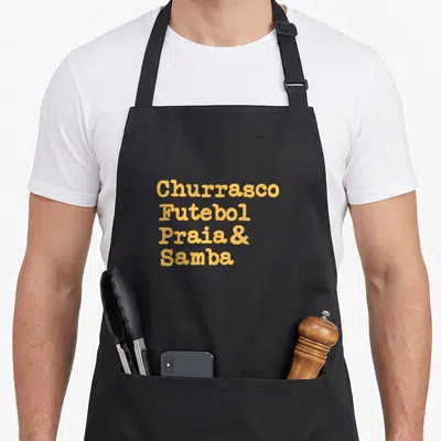 Tablier de cuisine noir avec inscription Churrasco Futebol Praia et Samba en lettres oranges arrondies.