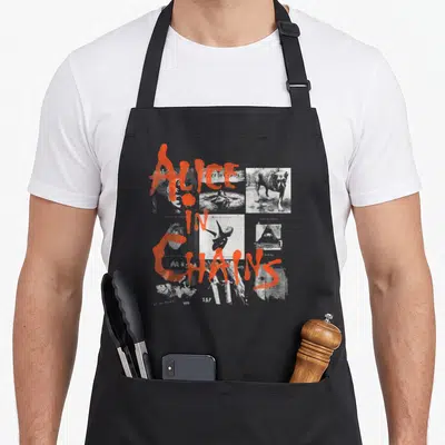 Tablier de cuisine noir avec collage d'albums Alice in Chains et texte orange graffiti.