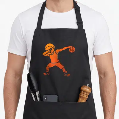 Tablier de cuisine noir avec un joueur de basket-ball orange effectuant une pose de danse.
