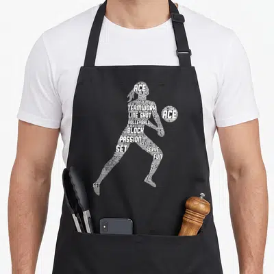 Tablier de cuisine noir avec silhouette de joueuse de volley-formée par des mots blancs comme ACE, BLOCK et PASSION.
