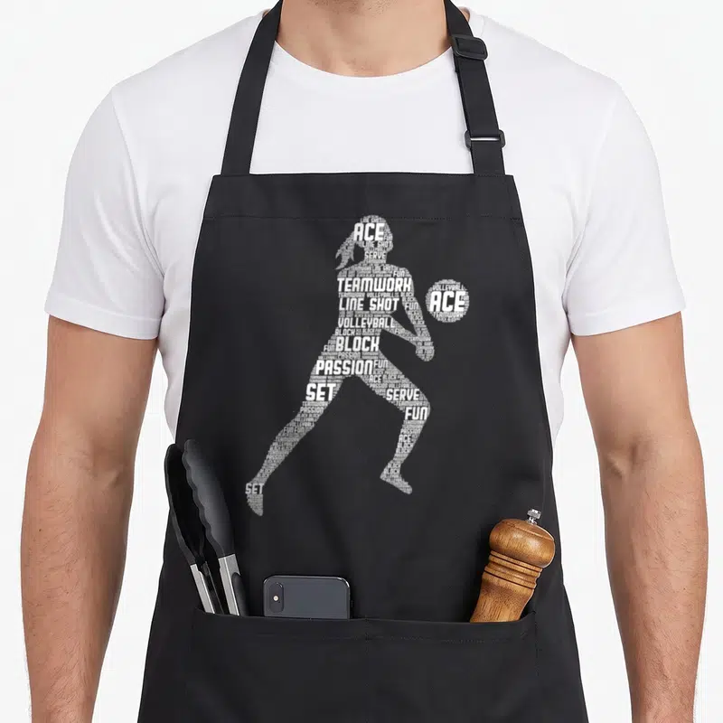 Tablier de cuisine noir avec silhouette de joueuse de volley-formée par des mots blancs comme ACE, BLOCK et PASSION.