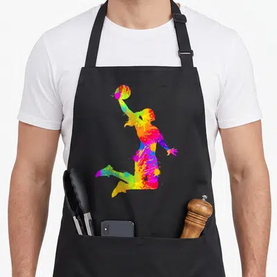 Tablier de cuisine noir avec silhouette femme basketball colorée en éclaboussures artistiques multicolores.