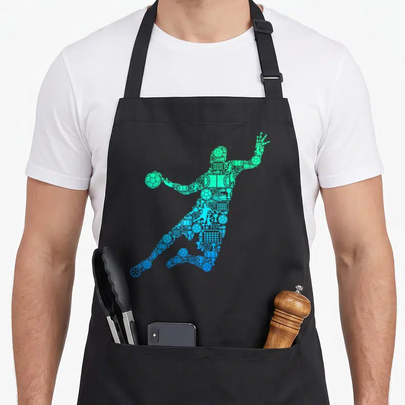 Tablier de cuisine noir avec silhouette de joueur de handball composée d'icônes sportives en dégradé bleu et vert.