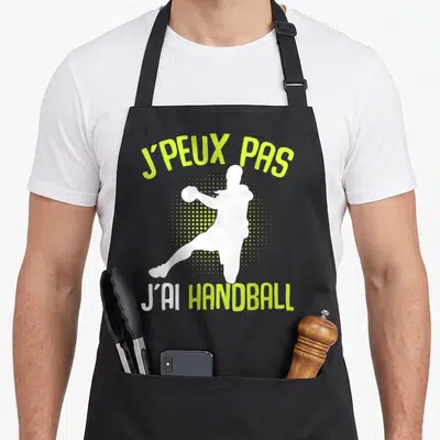 Tablier de cuisine noir avec silhouette blanche de joueur et texte vert lime J'peux pas j'ai handball