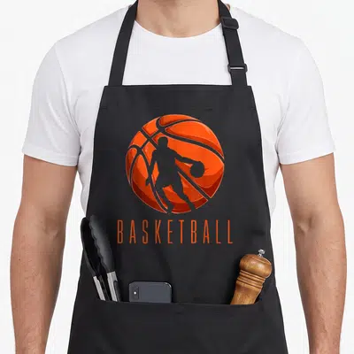 Tablier de cuisine noir avec une balle de basket orange et une silhouette de joueur en mouvement au centre.