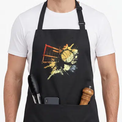 Tablier de cuisine noir avec illustration d'une balle de volley traversant un filet orange et des éclaboussures jaunes et bleues.