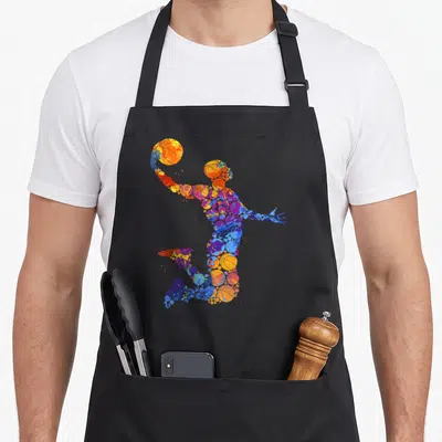 Tablier de cuisine noir avec silhouette de joueur de basket formée par des ballons multicolores en mouvement.