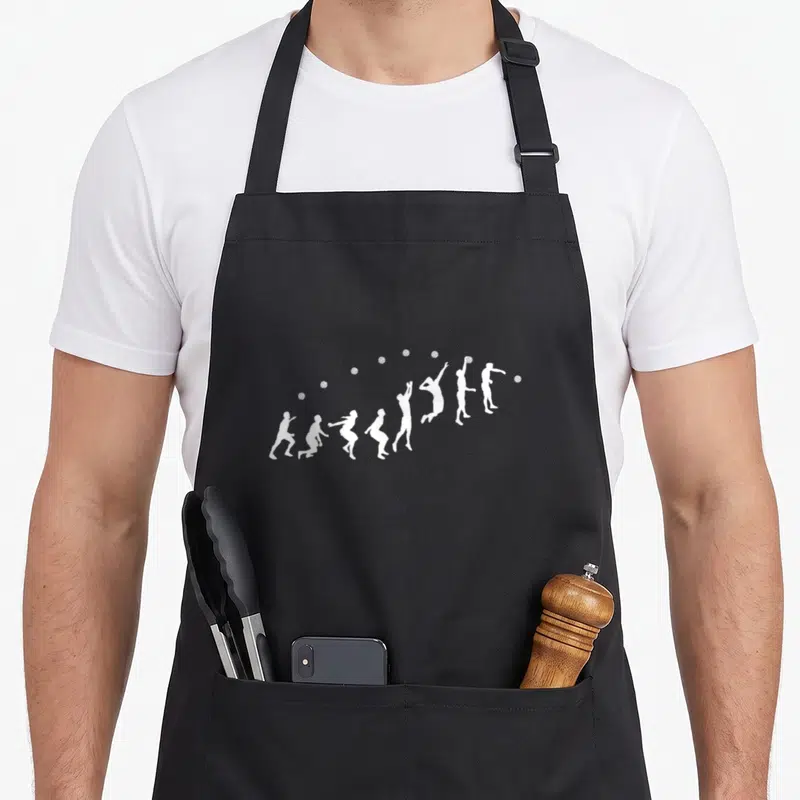 Tablier de cuisine noir avec des silhouettes blanches représentant un joueur de volley en train d'effectuer une pointe.