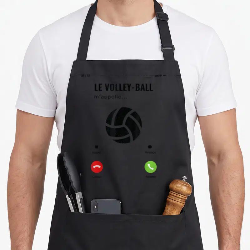 Tablier de cuisine noir avec illustration d'écran de téléphone affichant un ballon de volley et les boutons accepter ou refuser une appel.