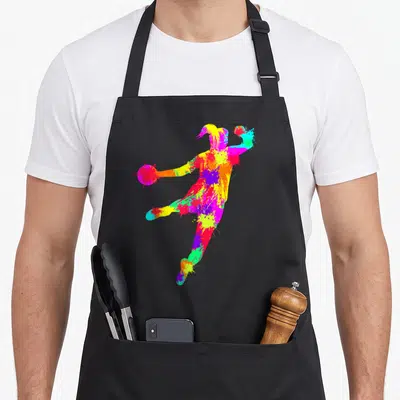Tablier de cuisine noir avec silhouette de joueuse de handball formée par des éclaboussures de peinture aux couleurs vives et contrastées.