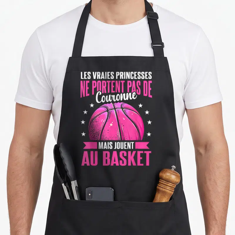 Tablier de cuisine noir avec une balle de basket rose et le texte Les vraies princesses ne jouent pas au basket.