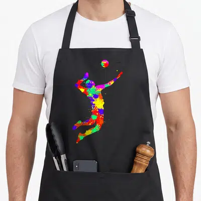 Tablier de cuisine noir avec une silhouette multicolore d'un joueur de volley en action, style éclaboussure de peinture.
