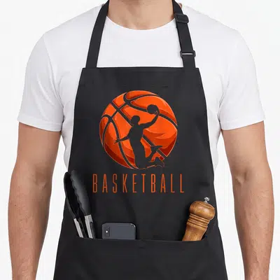 Tablier de cuisine noir avec une balle de basket orange et une silhouette de joueur en action au centre.