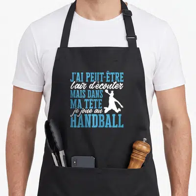 Tablier de cuisine noir avec texte bleu blanc et silhouette sautant d'un handballeur